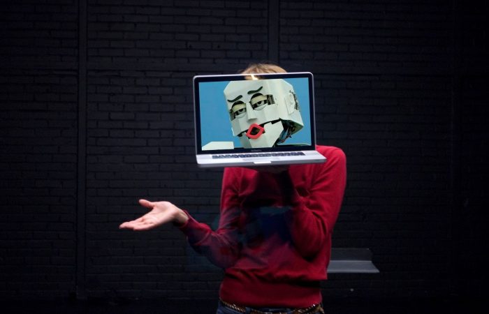 Person with laptop infront of face with robot face on screen